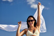© Syda Productions - people, summer and swimwear concept - happy smiling young woman in bikini swimsuit with cover-up over blue sky