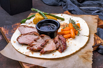 Wall Mural - Sliced Duck breast with berry sauce on the board