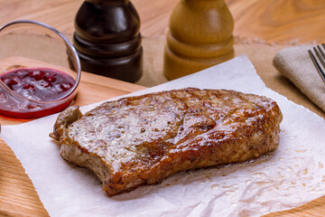 Sticker - juicy Striploin Steak on wooden board with sauces