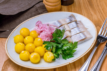 Poster - Herring with potatoes and red onion on white plate