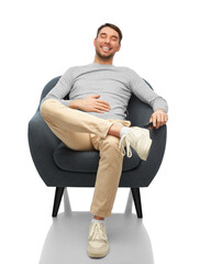 Sticker - people and furniture concept - happy smiling man sitting in chair and touching his tummy over white background