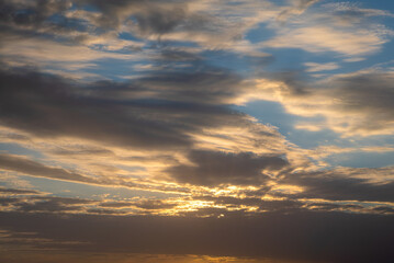 Wall Mural - Wonderful view of cumulus clouds sky with orange sun light at sunset of summer