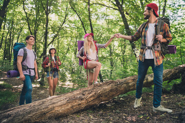 Wall Mural - Photo of best friend couples happy positive smile hiking forest trip bag explore man help girl expedition outdoors