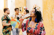 © kleberpicui - Brazilian Carnival. Woman drinking water during carnival block on the street