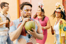 Brazilian Carnival. Concept Of Care During Carnival. Person Hydrating Himself By Drinking Coconut Water