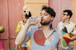 © kleberpicui - Brazilian Carnival. Person drinking water during carnival block on the street
