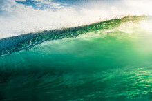 Surfing Wave In Atlantic Ocean With Sunshine. Glassy Turquoise Wave In Sunny Day