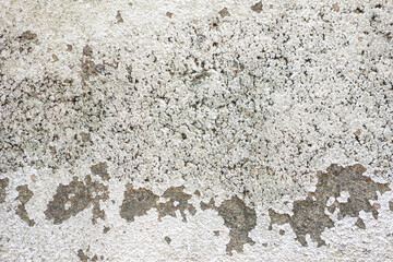 The old and damaged white concrete surface is uneven.