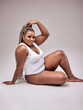 © Roman - Self Acceptance, Love And Care. Portrait of smiling fat black woman with perfect skin and body isolated in studio background, free copy space. Gorgeous Lady with chubby body enjoy herself