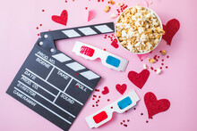 St. Valentine's Day Movie Night Concept. Popcorn, 3d Glasses Clapper Board On Pink  Background. Cozy Holiday Plans For Lovers