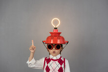 Smart Child Wearing Funny Helmet With Illuminated Lightbulb