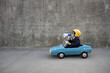© Sunny studio - Funny businessman driving retro pedal car outdoor