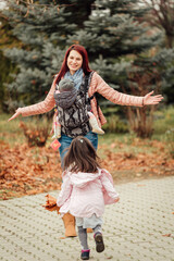 Wall Mural - Mother with two daughters playing in the park