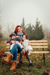 Mother with two girls outdoors in the park on a bench