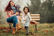 Mother with two girls outdoors in the park