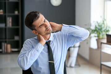 Wall Mural - Businessman feeling neck pain in office