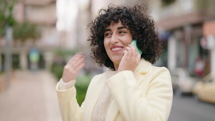 Sticker - Young woman smiling confident talking on the smartphone at street