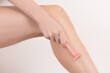 © olga_demina - young woman leg with razor in hand shaving removing hair. body care depilation
