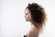 © Nikola Spasenoski - Beautiful brunette girl with long curly hair. Studio portrait on white background