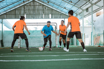 Wall Mural - players in blue uniforms dribble past several opposing players