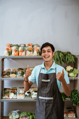 Wall Mural - Handsome man in apron with two thumbs up