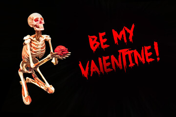 scary card Be my Valentine. skeleton keeps its heart isolated on a black background. Life, love and death concept. immortal love. marriage proposal