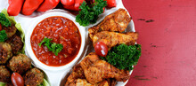 Super Bowl Sunday Football Party Celebration Food Platter With Chicken Buffalo Wings, Meat Balls, Hot Dogs On Red Wood Table, With Copy Space. Sized To Fit Popular Social Media And Web Banner.