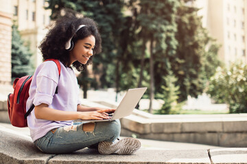 Wall Mural - African American Female Student Using Laptop Learning Sitting Outdoor