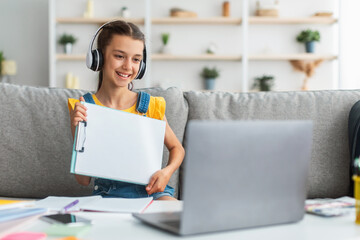 Poster - Girl sitting at desk, using pc, showing paper