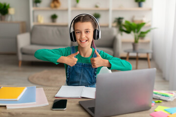 Poster - Girl sitting at desk, using laptop, showing thumbs up