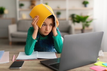 Aufkleber - Tired small school girl holding notebook on her head