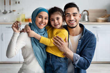 Poster - Family Housing Concept. Happy Islamic Spouses With Little Daughter Holding Home Keys