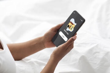 Poster - Black woman in bed login smart home system on cellphone
