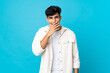 © luismolinero - Young Argentinian man isolated on background happy and smiling covering mouth with hand