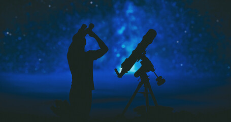 Wall Mural - Amateur astronomer searching stars and planets on a night sky with telescope and binoculars.