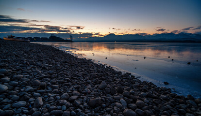 Wall Mural - Sunset at coast of the lake. Nature landscape. Nature in Slovakia. Reflection, blue sky and yellow sunlight. landscape during sunset..