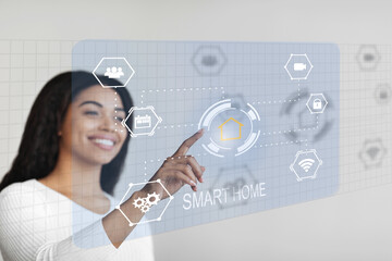 Poster - Happy african american woman controlling house functions via virtual panel