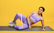 © Prostock-studio - Full length shot of active black woman doing crossfit exercise with resistance elastic expander, yellow background