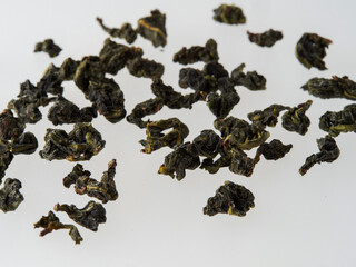 Wall Mural - Dry tea leaves isolated on a white background.