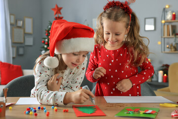 Wall Mural - Cute little children making beautiful Christmas greeting cards at home