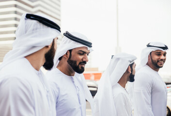 Wall Mural - Group of business managers from the emirates meeting and working together in Dubai. Arabian businessmen wearing traditional clothes