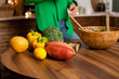 © Dina - Woman in green shirt cooking a salad at home in the kitchen. making vegan dinner or lunch with fresh vegetables. Healthy and eco conscious vegetarian lifestyle.