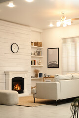 Sticker - Stylish living room interior with comfortable sofa and decorative fireplace