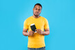 © Prostock-studio - Frustrated Traveler Guy Holding Travel Tickets After Cancellation, Blue Background