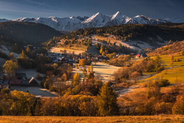 Colorful autumn near the Tatras. Peaks and hills bathed in the light of the setting sun.