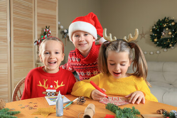 Wall Mural - Cute little children making beautiful Christmas greeting cards at home