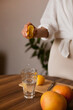 © Dina - woman making lemon water in the kitchen at home - healthy eating and lifestyle
