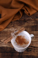 Sticker - Coffee with cinnamon on a wooden table