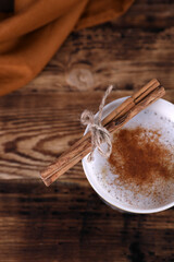 Wall Mural - Coffee with cinnamon on a wooden table