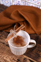 Wall Mural - Coffee with cinnamon on a wooden table